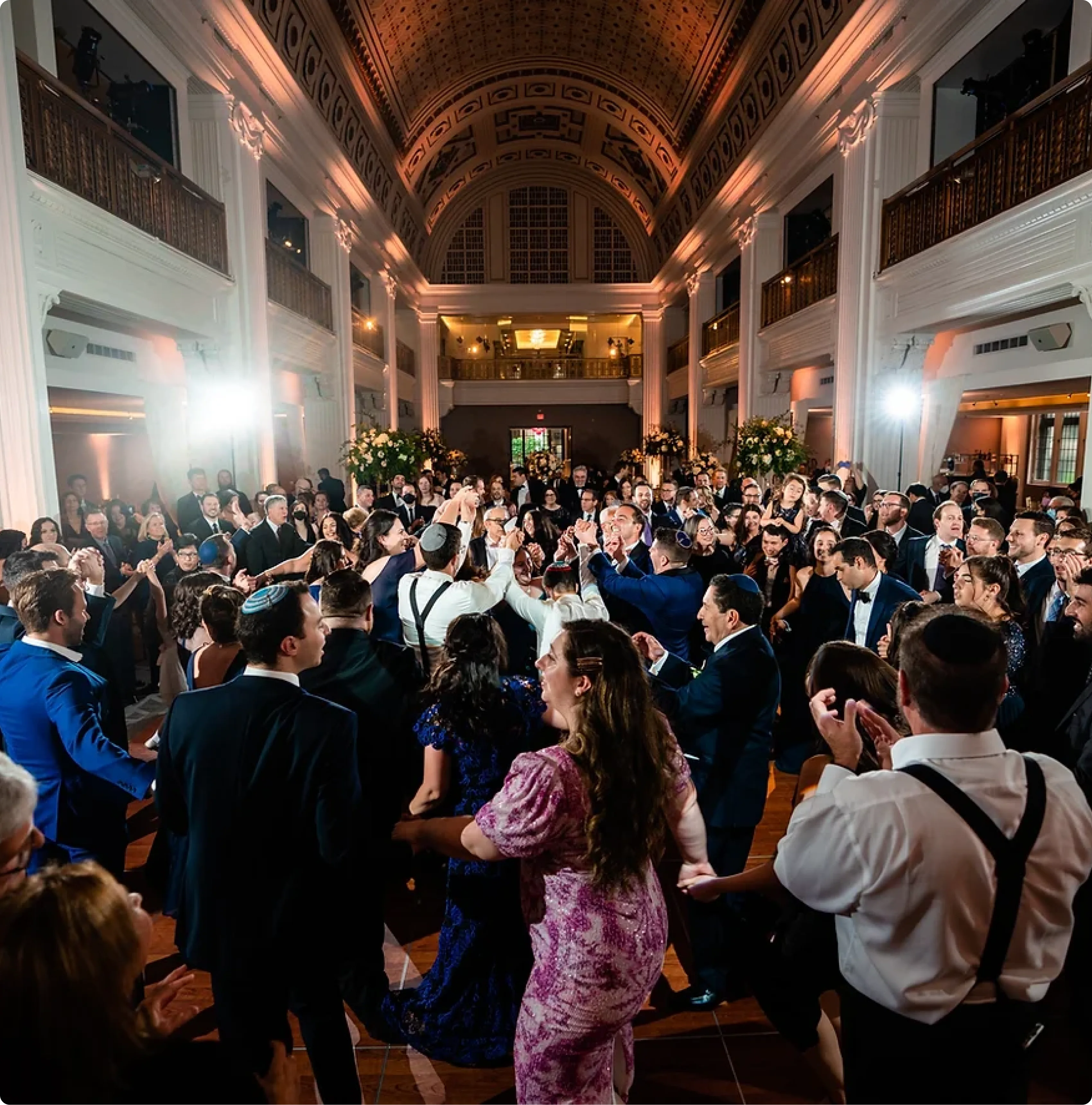 Wedding guests dancing the hora in a grand ballroom