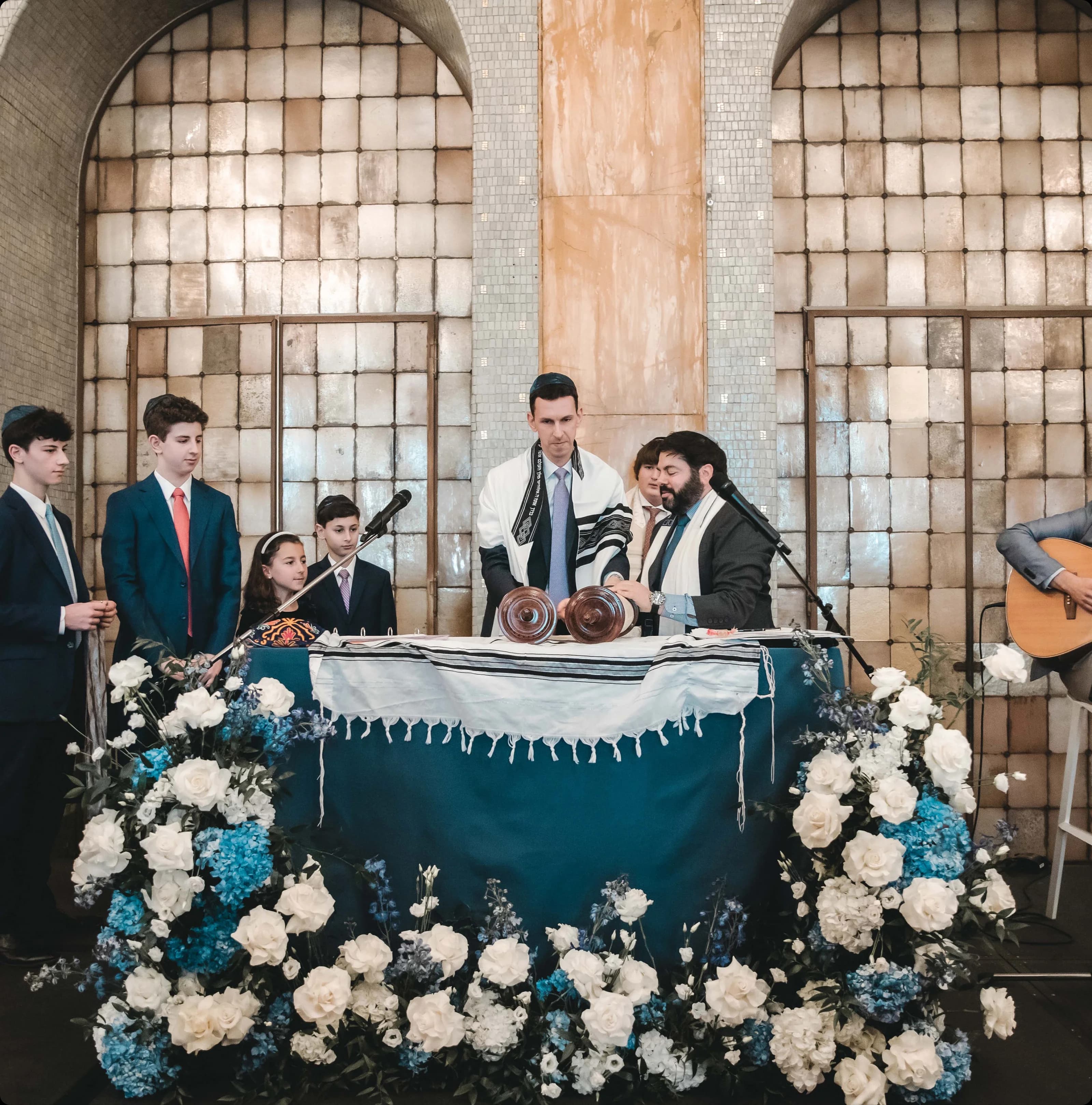 A family gathered at the bimah during a bar mitzvah service