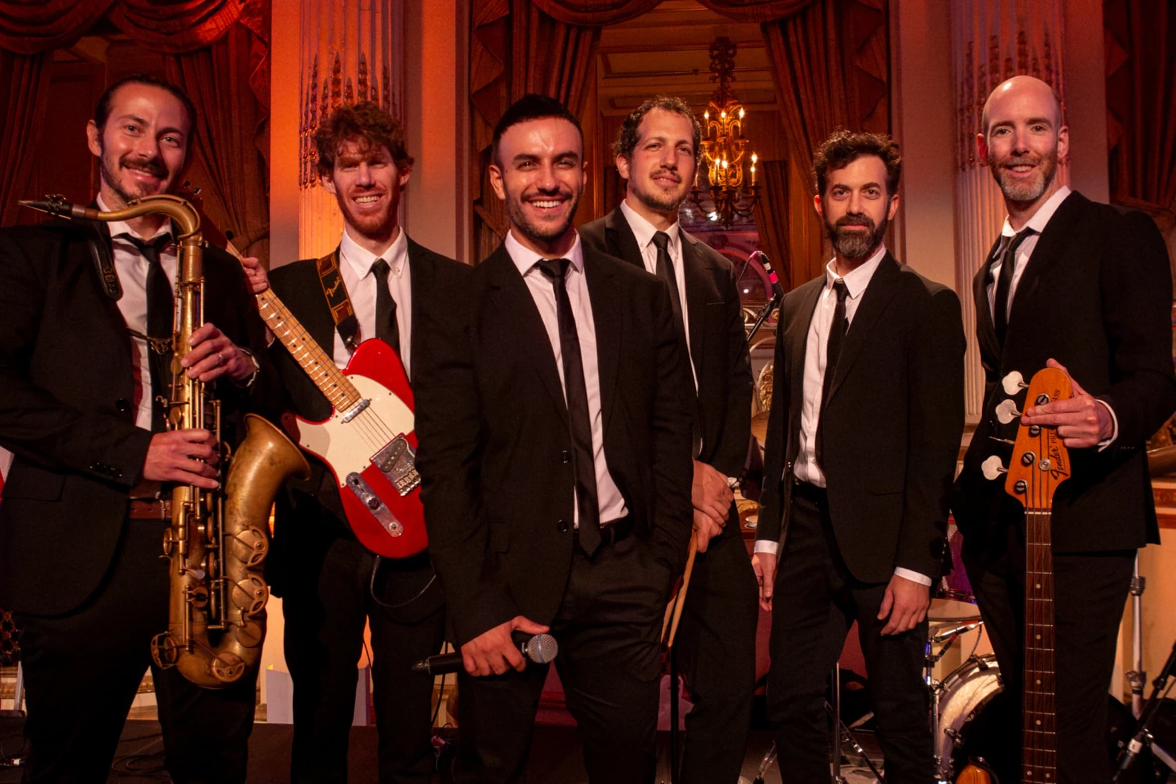 The Shuk's musicians in black tie on a ballroom stage